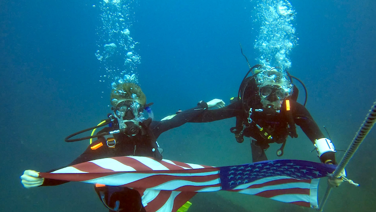 Holding flag underwater